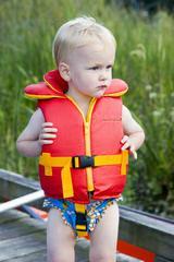 Toddler in a water safety jacket